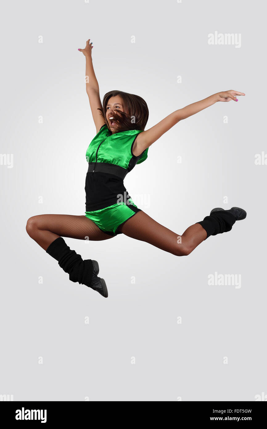 Young female dancer jumping against white background Stock Photo - Alamy