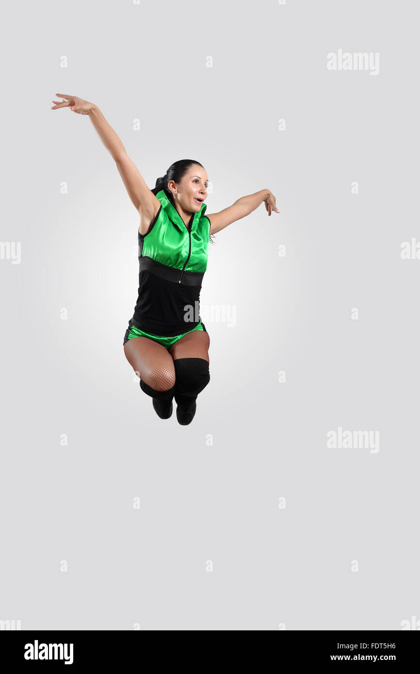 Young female dancer jumping against white background Stock Photo - Alamy
