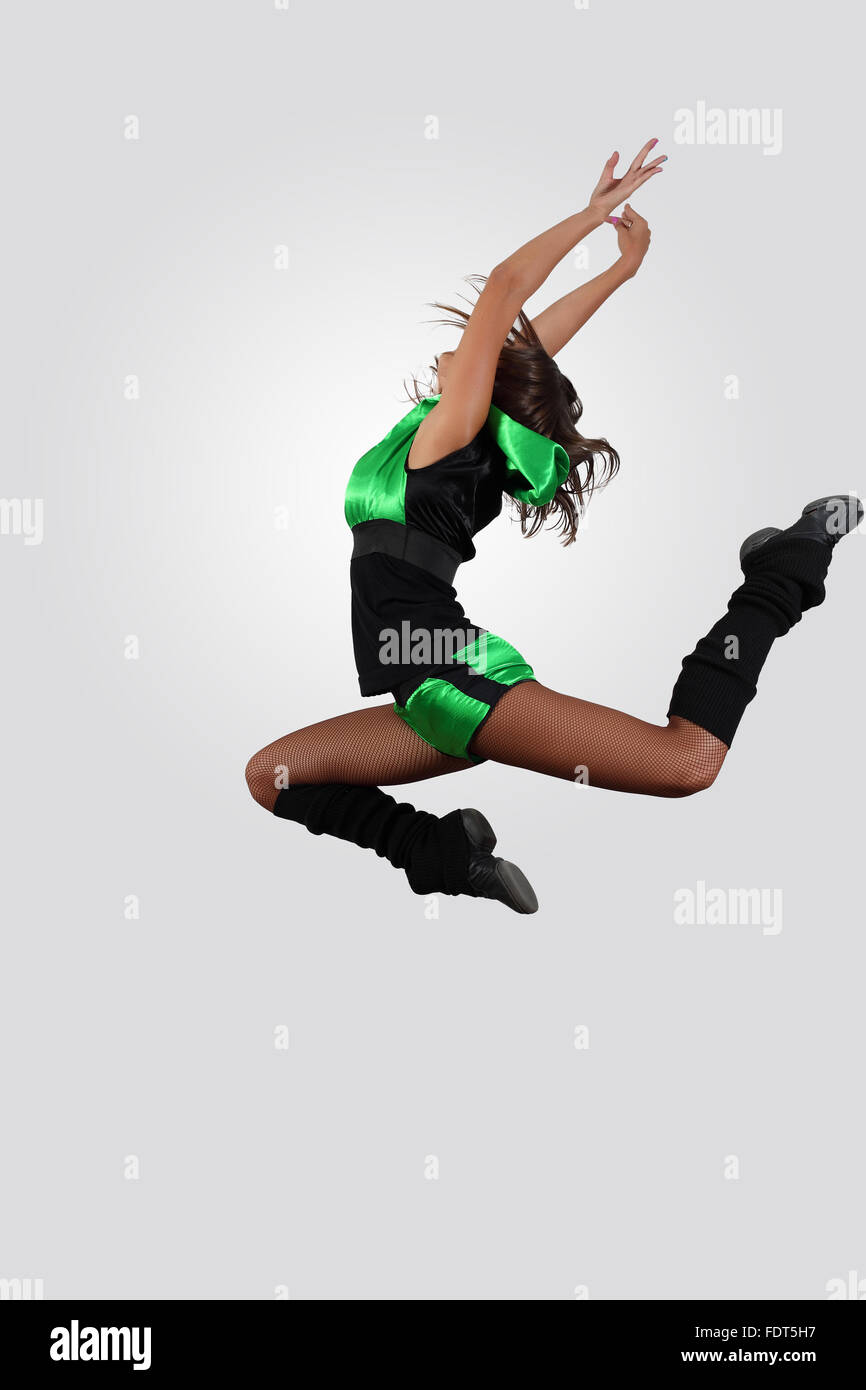 Young female dancer jumping against white background Stock Photo - Alamy