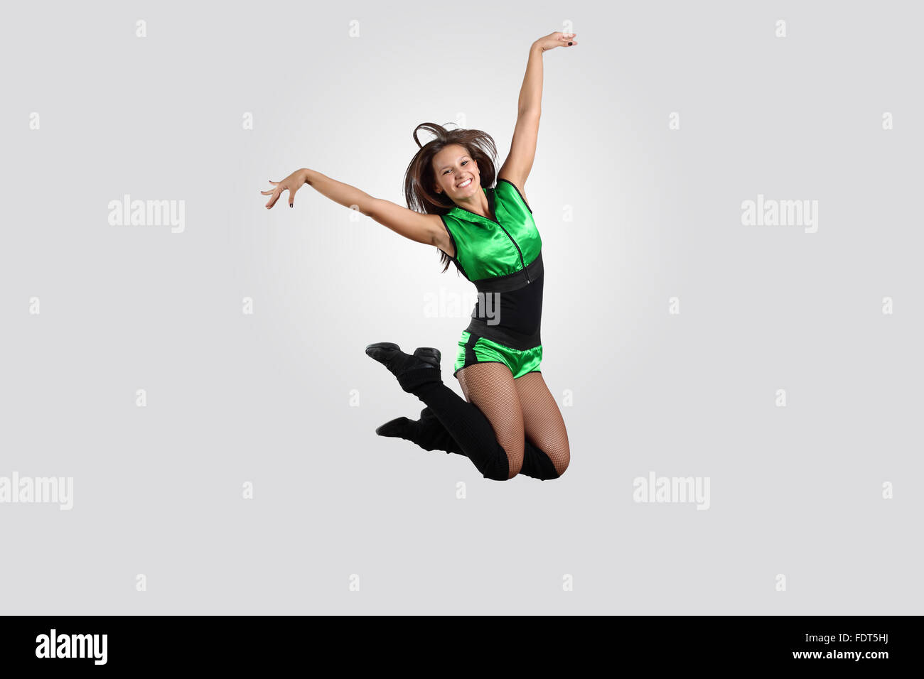 Young female dancer jumping against white background Stock Photo - Alamy