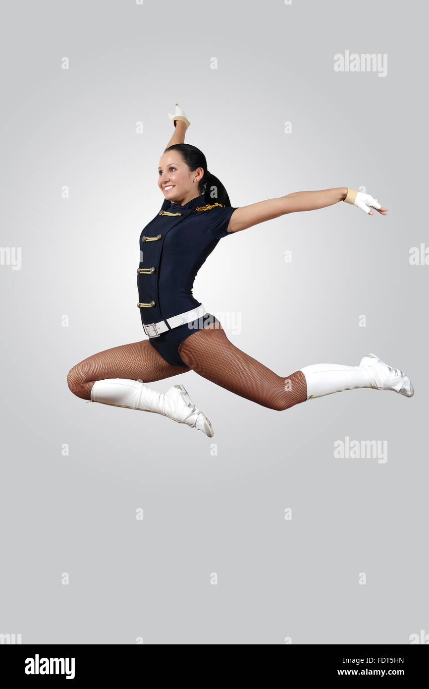 Young female dancer jumping against white background Stock Photo - Alamy