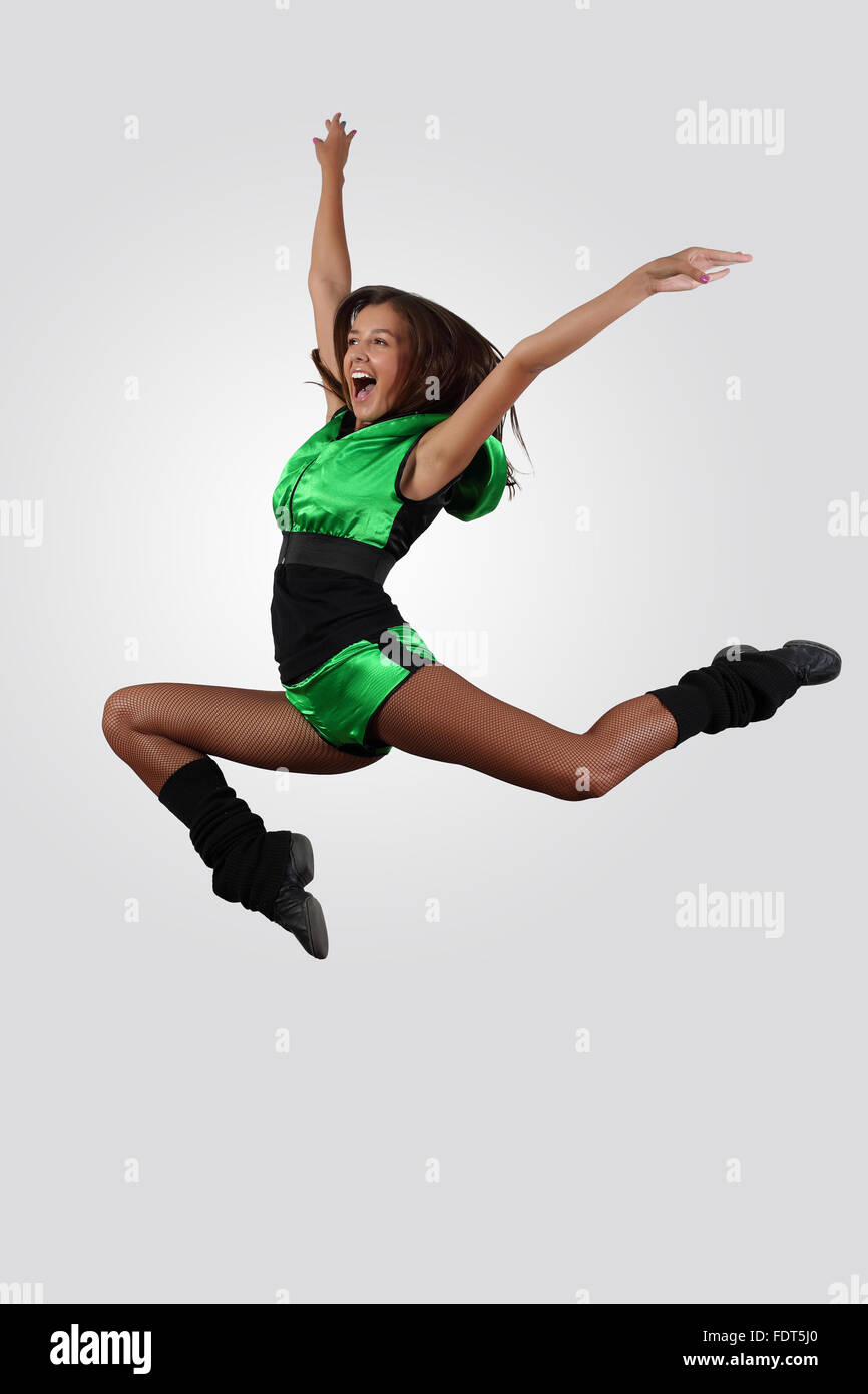 Young female dancer jumping against white background Stock Photo - Alamy