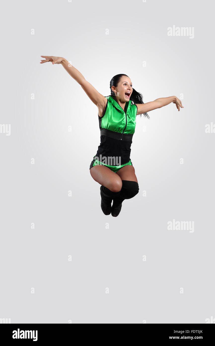 Young female dancer jumping against white background Stock Photo - Alamy