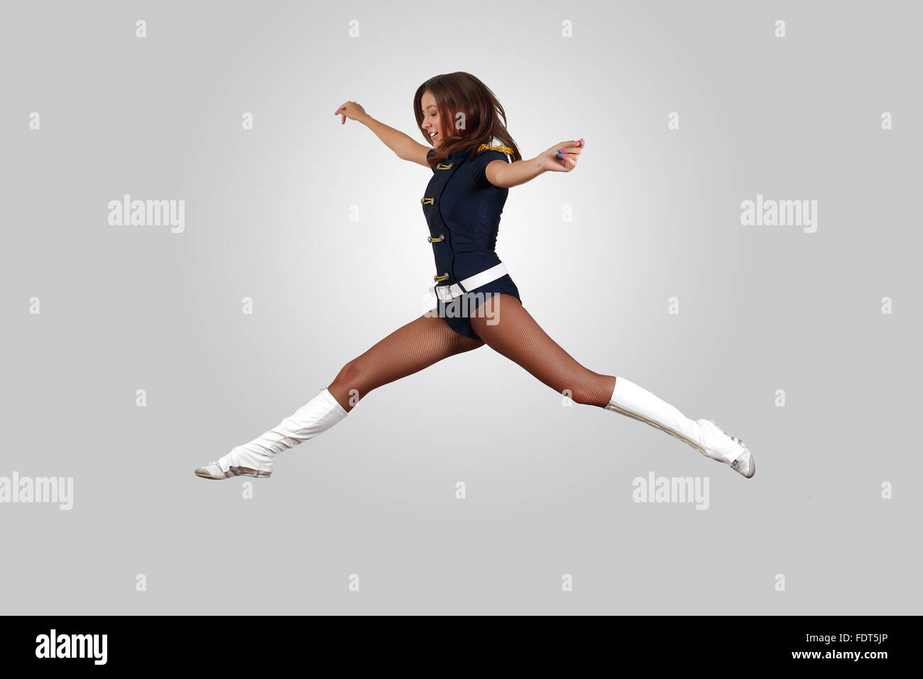 Young female dancer jumping against white background Stock Photo - Alamy