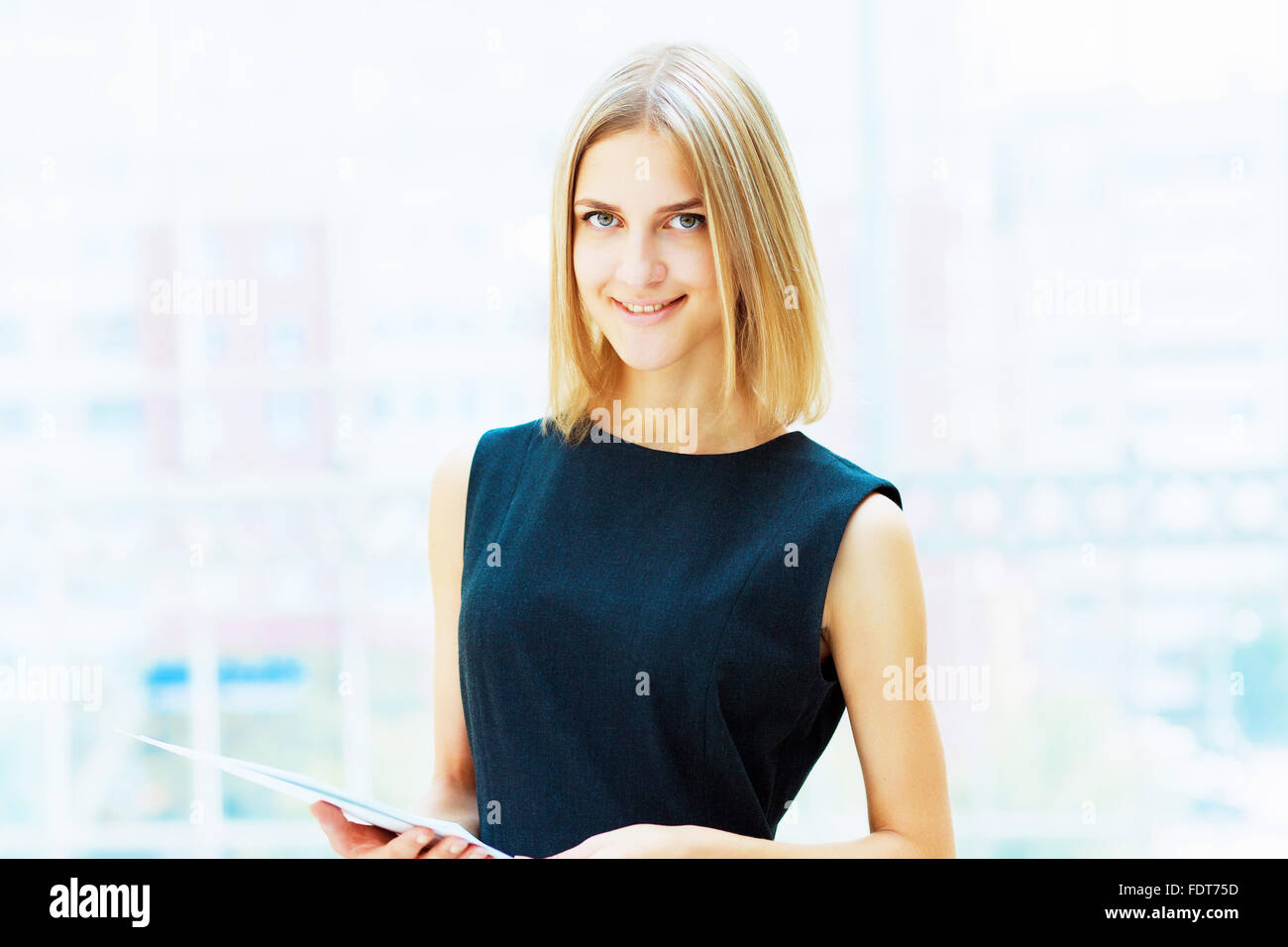 A portrait of a young business woman in an office Stock Photo - Alamy