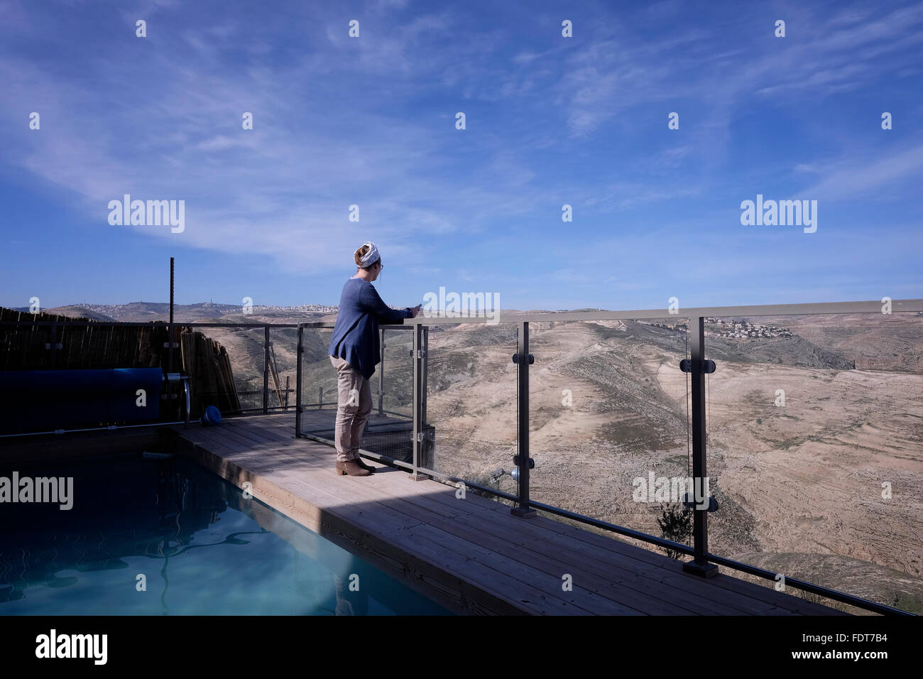 Miri Maoz Ovadia a Jewish settler from Mitzpe Nof settlement gazing at the Judean hills from the swimming pool of Nof Canaan B&B in Nofei Prat Jewish settlement in the West Bank Israel on 01 February 2016. The Palestinian Authority has asked Airbnb to remove Israeli listings in West Bank settlements from its site. The Palestinians are complaining that by contributing to the economy in Judea and Samaria, Airbnb, like other companies doing business there, helps perpetuate Israel’s 'settlement” enterprise. Stock Photo