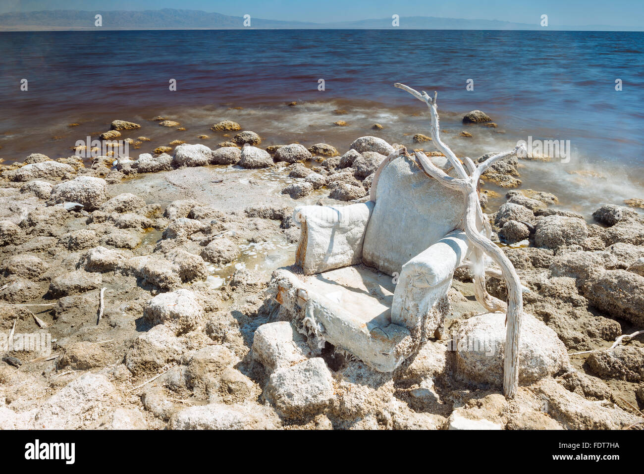 A discarded chair on the western shore of the Salton Sea, California Stock Photo