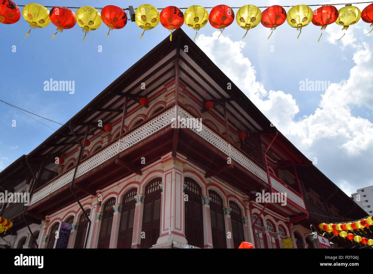 Shop house in Chinatown, Singapore during Chinese New Year with a string of red and yellow Chinese lanterns Stock Photo