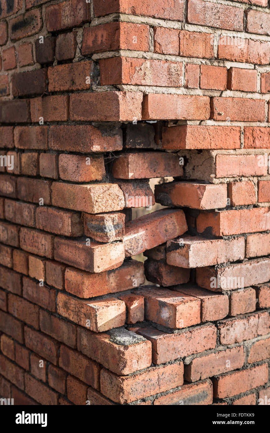 Damage to the corner of a brick building. Stock Photo