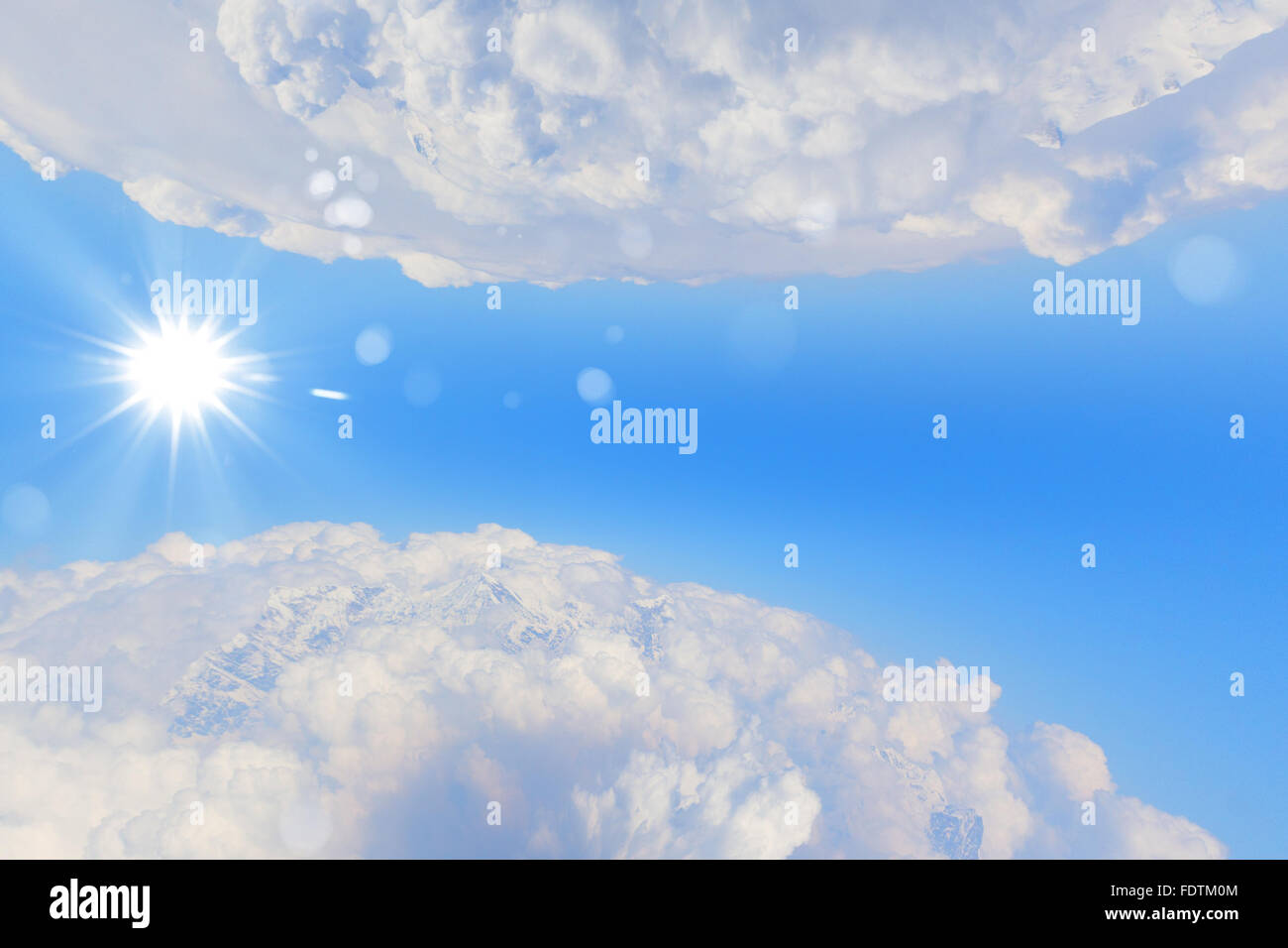 bright blue sky with sun shining and some clouds Stock Photo - Alamy