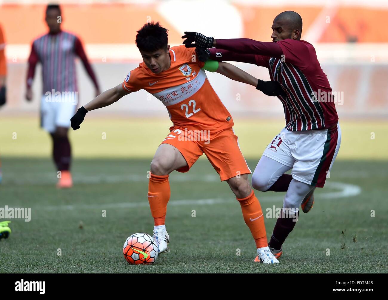 Jinan, China's Shandong Province. 2nd Feb, 2016. Hao Junmin (L) of China's Shandong Luneng FC competes during the preliminary round match against India's Mohun Bagan at the 2016 AFC Champions League in Jinan, capital of east China's Shandong Province, on Feb. 2, 2016. China's Shandong Luneng FC won 6-0. © Zhu Zheng/Xinhua/Alamy Live News Stock Photo