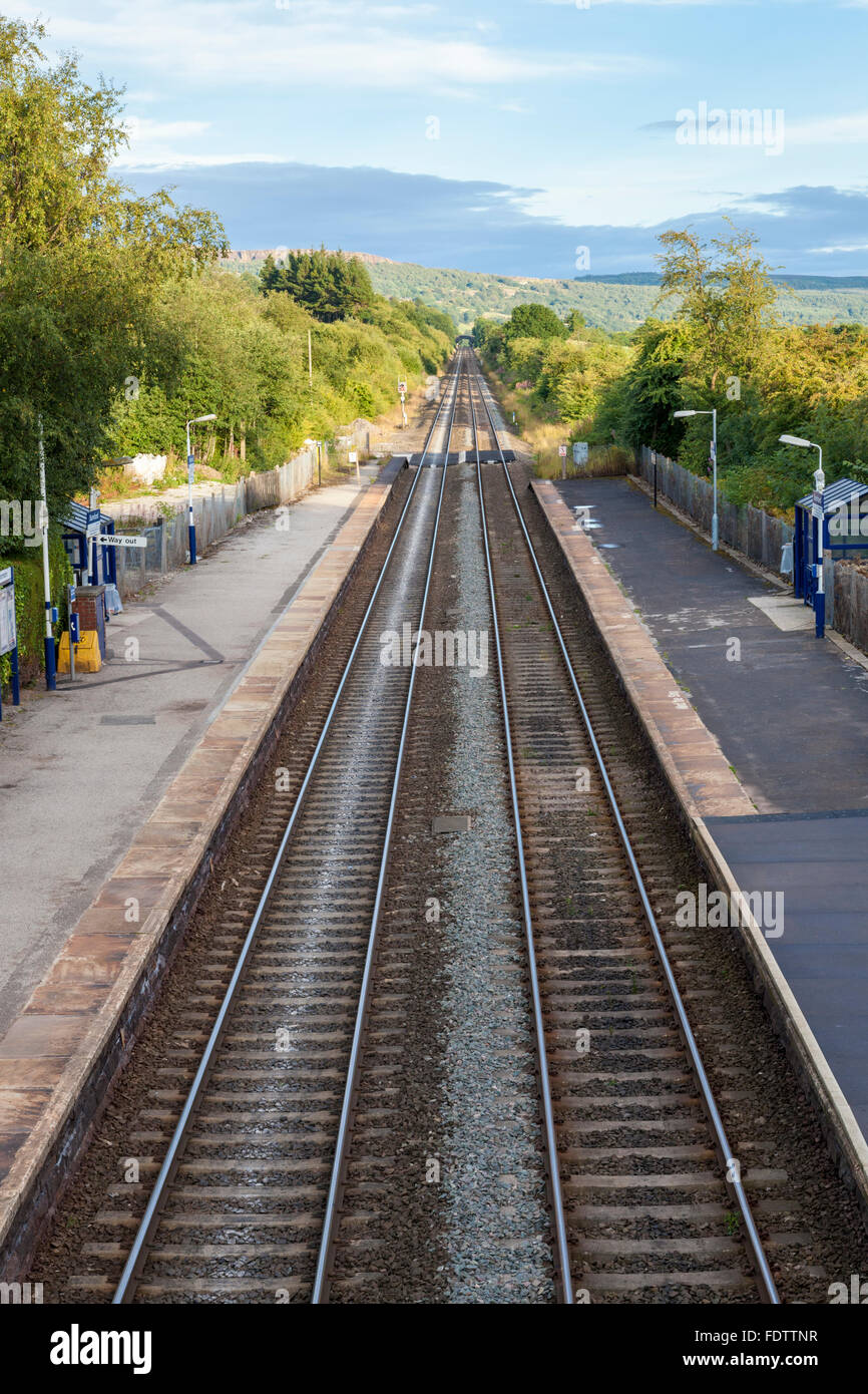 The rural train station at Bamford with a straight railway line continuing on into the countryside, Derbyshire, Peak District, England, UK Stock Photo