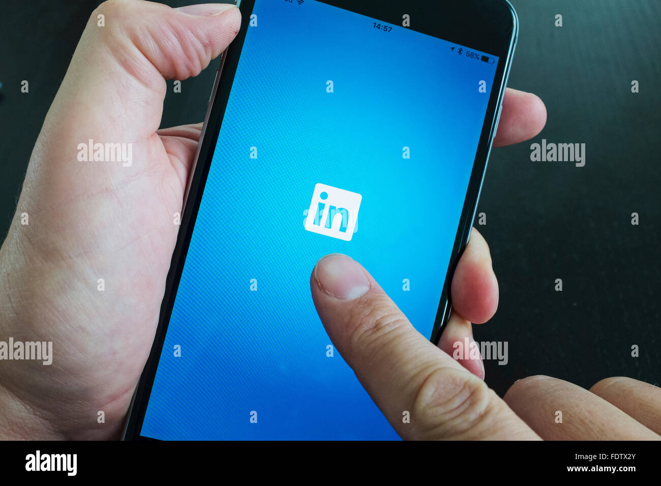 LinkedIn professional social networking app logo on screen of iPhone 6 Plus smart phone Stock Photo