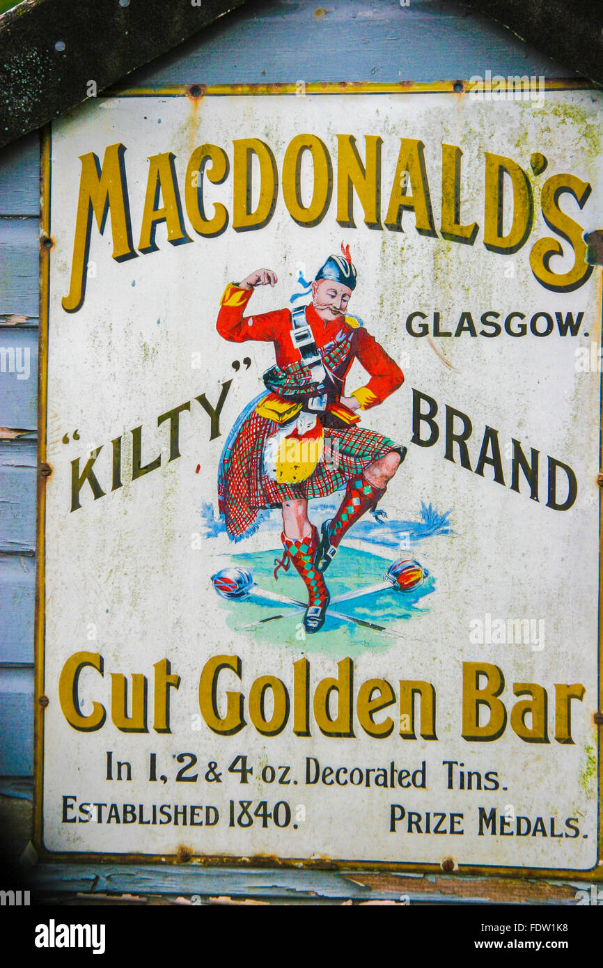 A old sign on the end of a wooden building, Scotland. Stock Photo