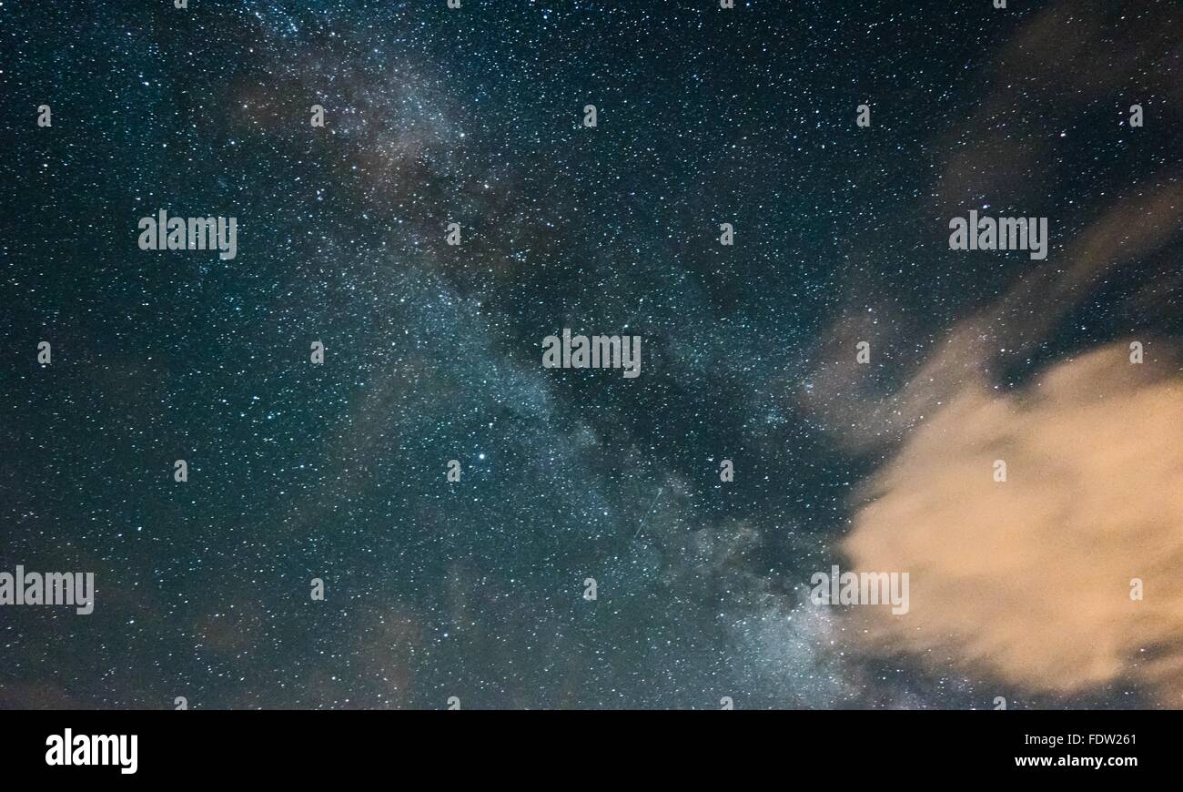 Milky way hiding over cloud Stock Photo - Alamy