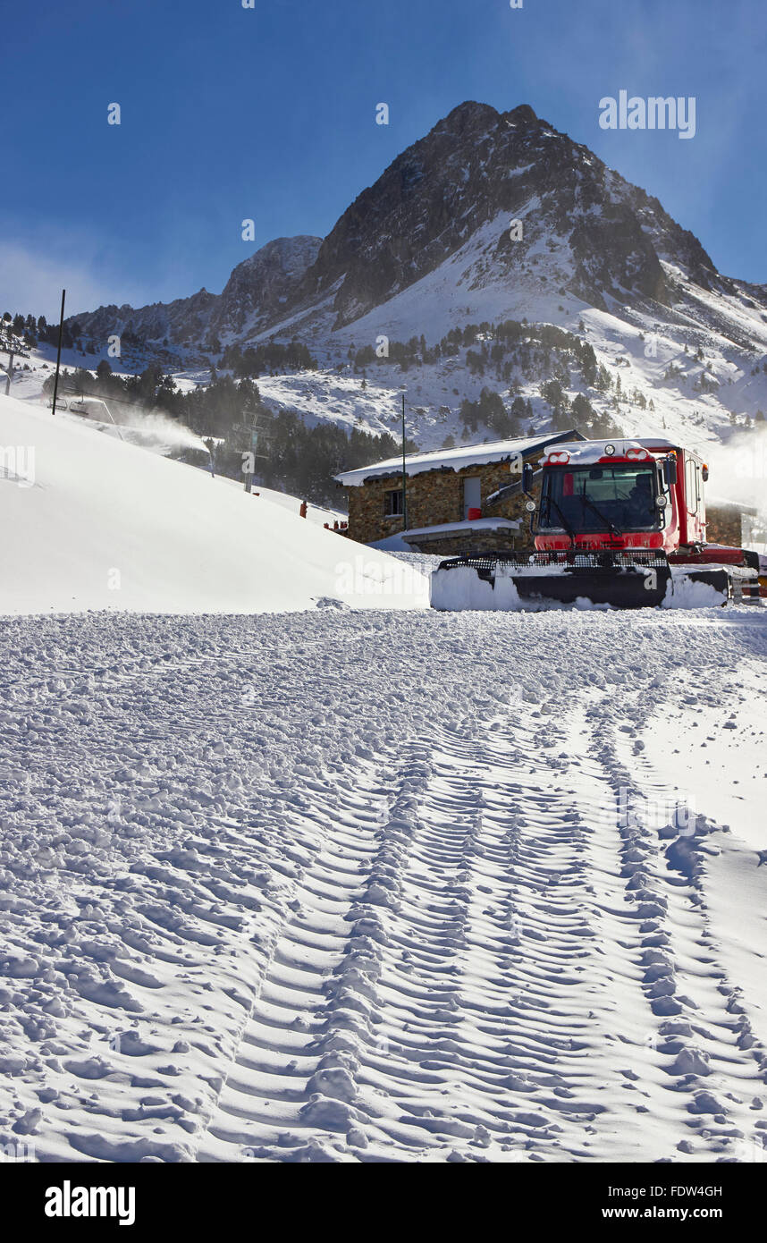 Red ratrack vehicle for snow preparation at ski resort in Andorra, Pyrenees mountain, Europe Stock Photo