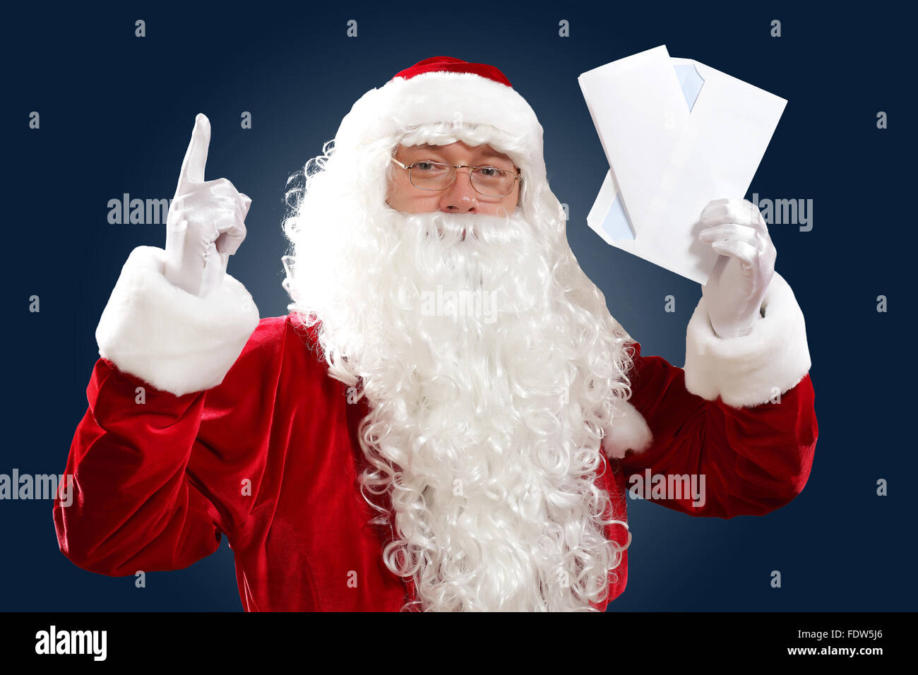 Santa Claus holding and reading a letter to him Stock Photo - Alamy