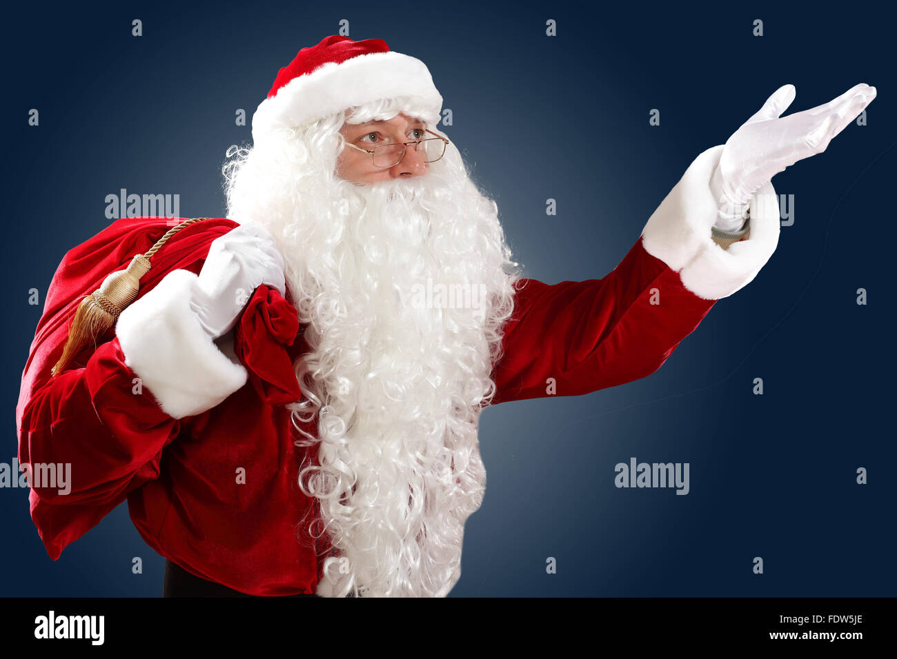 Santa Claus with his magic gift red bag full of presents Stock Photo ...