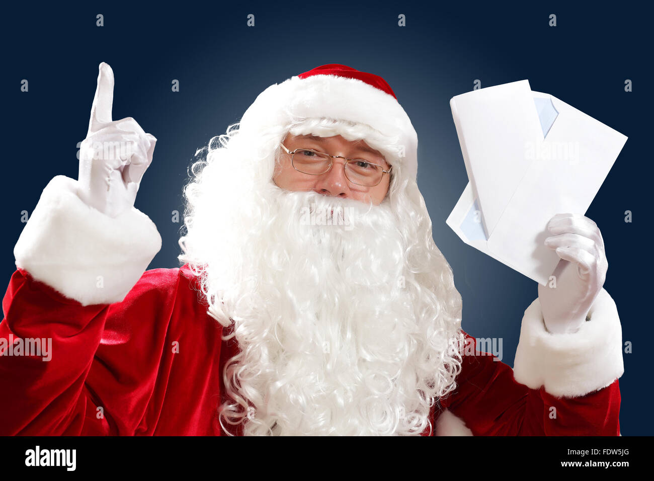 Santa Claus holding and reading a letter to him Stock Photo - Alamy