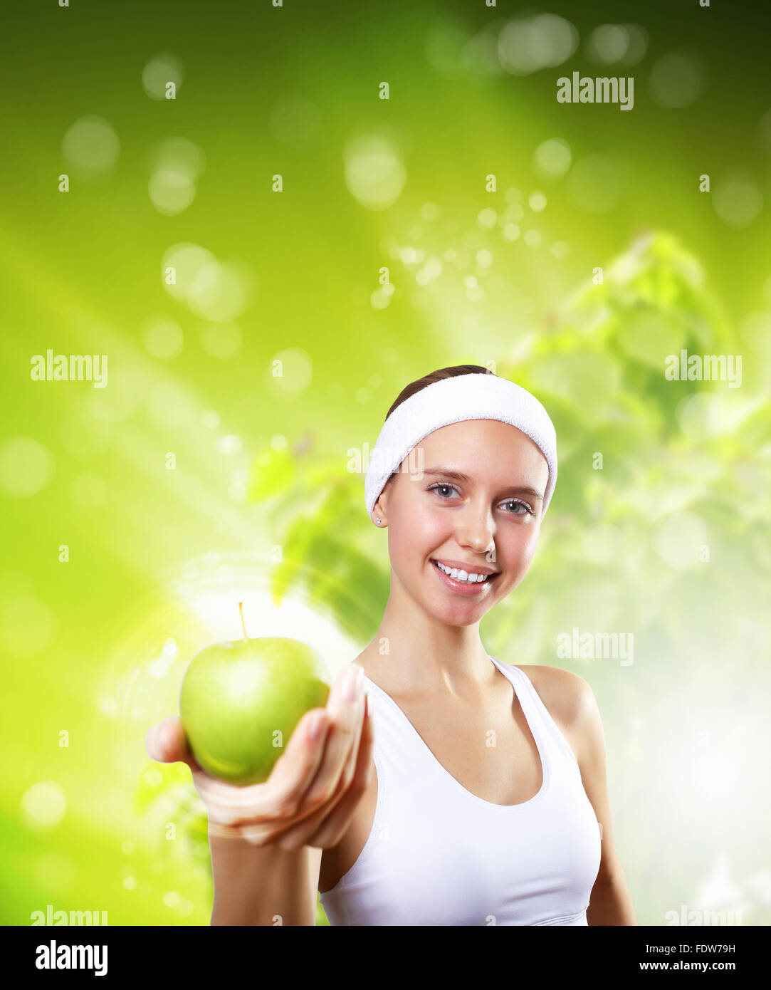 Young pretty girl in sport wear with green apple Stock Photo - Alamy