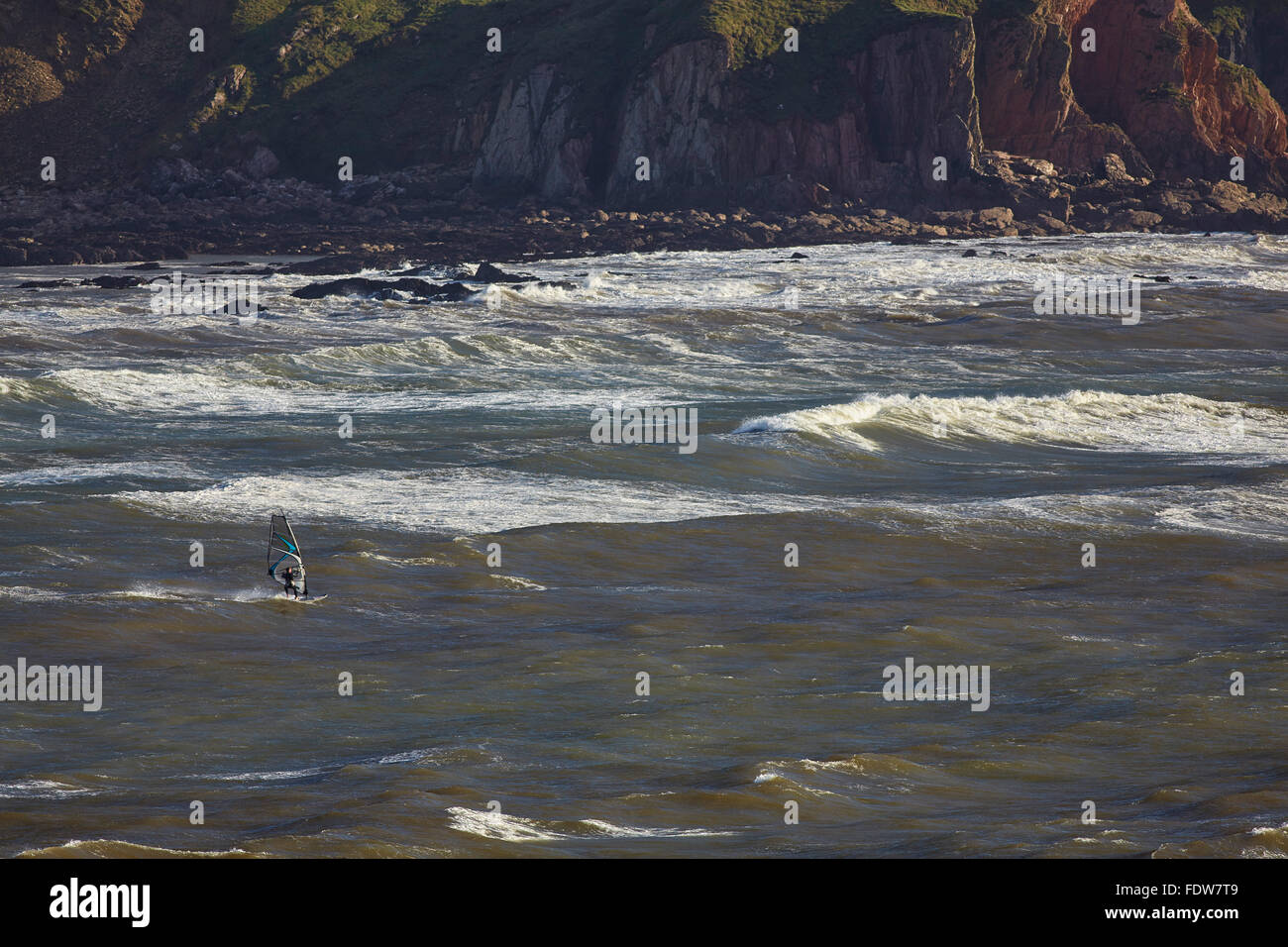 Windsurfers in storm surf at Bigbury-on-Sea, Devon, Great Britain. Stock Photo