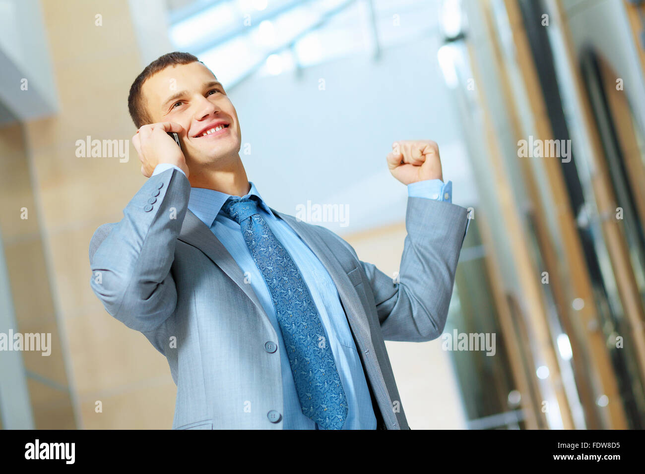 Portrait of happy smiling young businessman, standing in office Stock ...