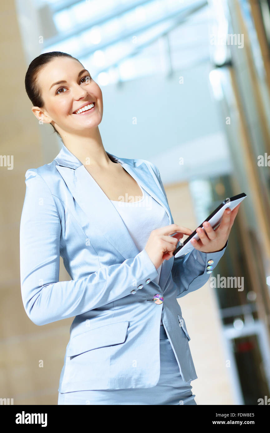 Portrait of happy smiling young businesswoman in office Stock Photo - Alamy