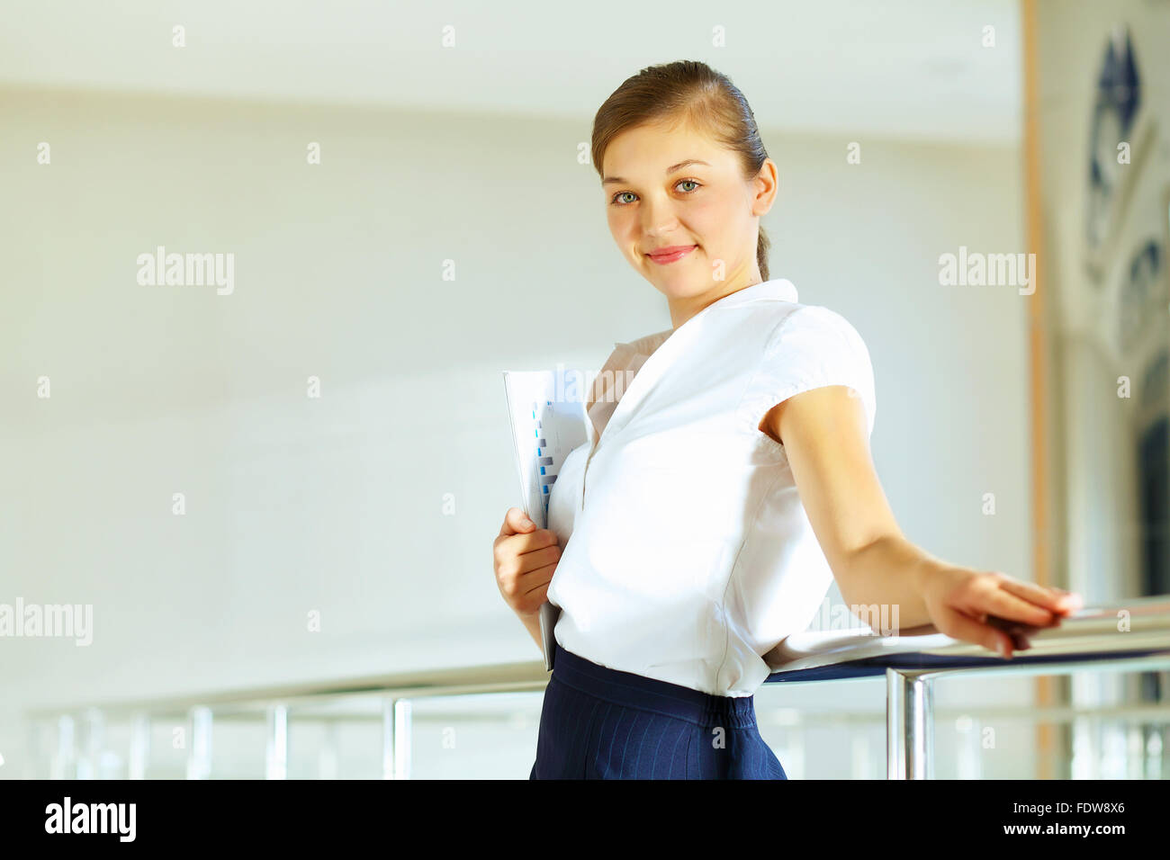 Portrait of happy smiling young businesswoman in office Stock Photo - Alamy