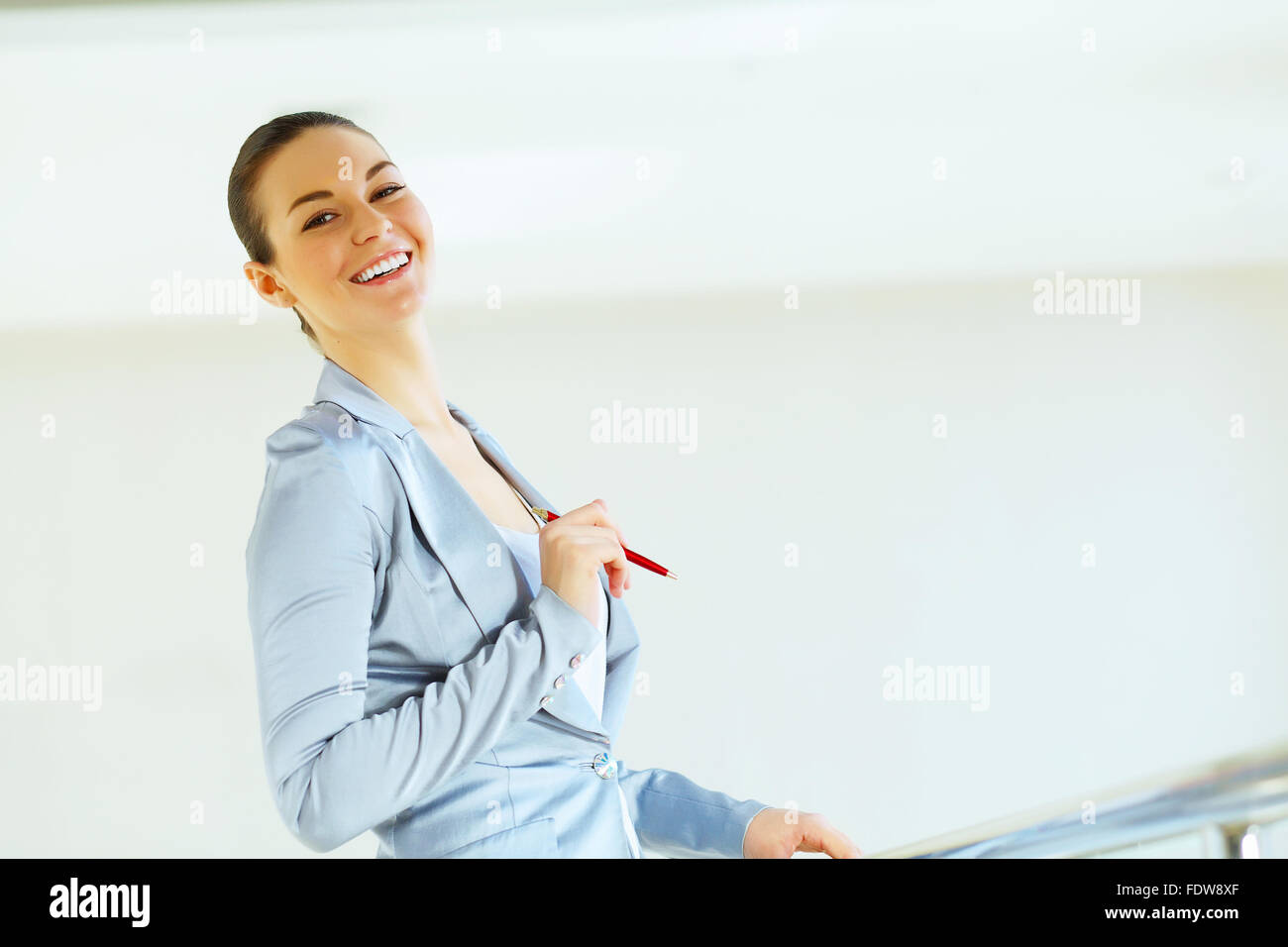 Portrait of happy smiling young businesswoman in office Stock Photo - Alamy
