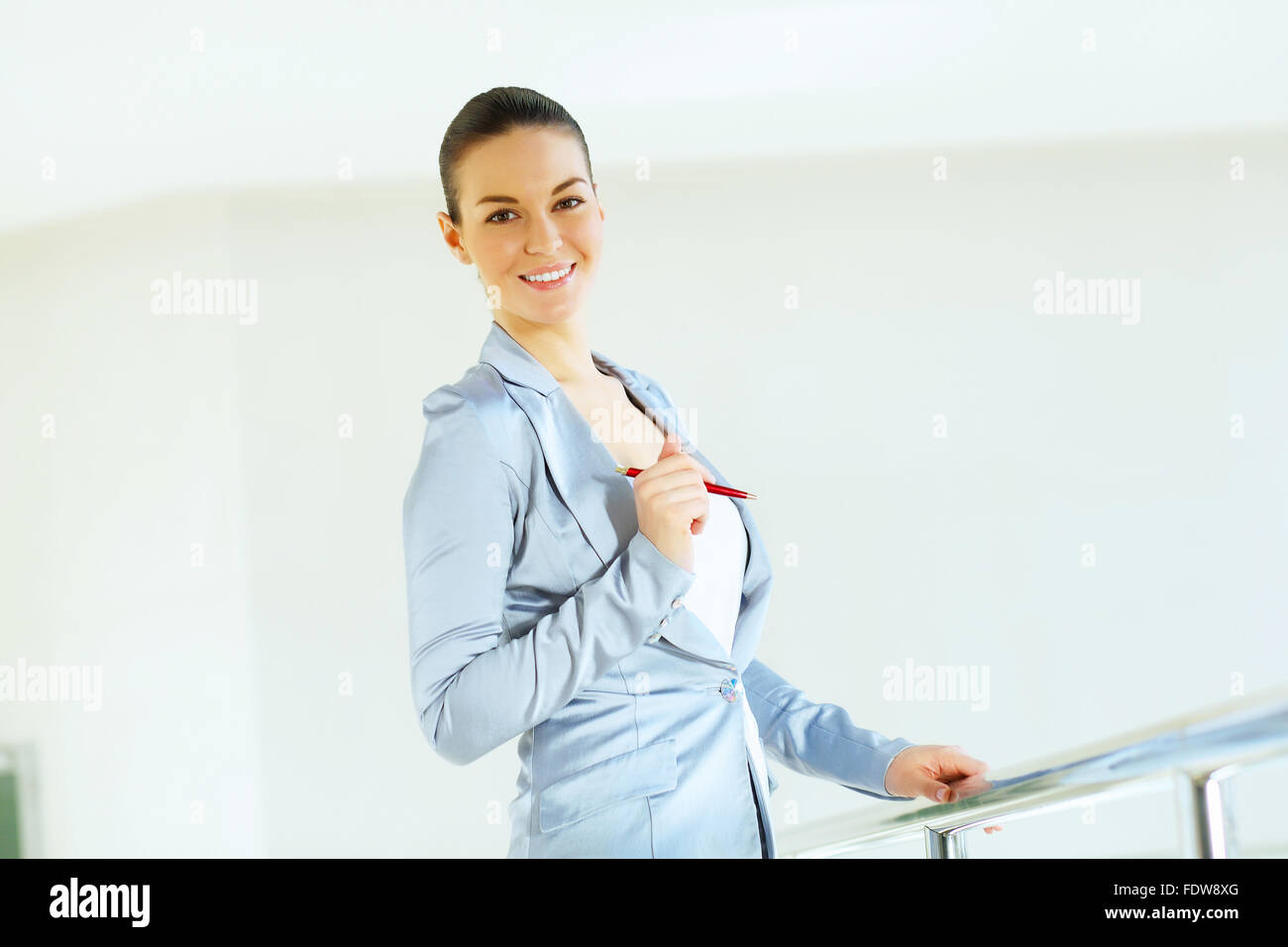 Portrait of happy smiling young businesswoman in office Stock Photo - Alamy
