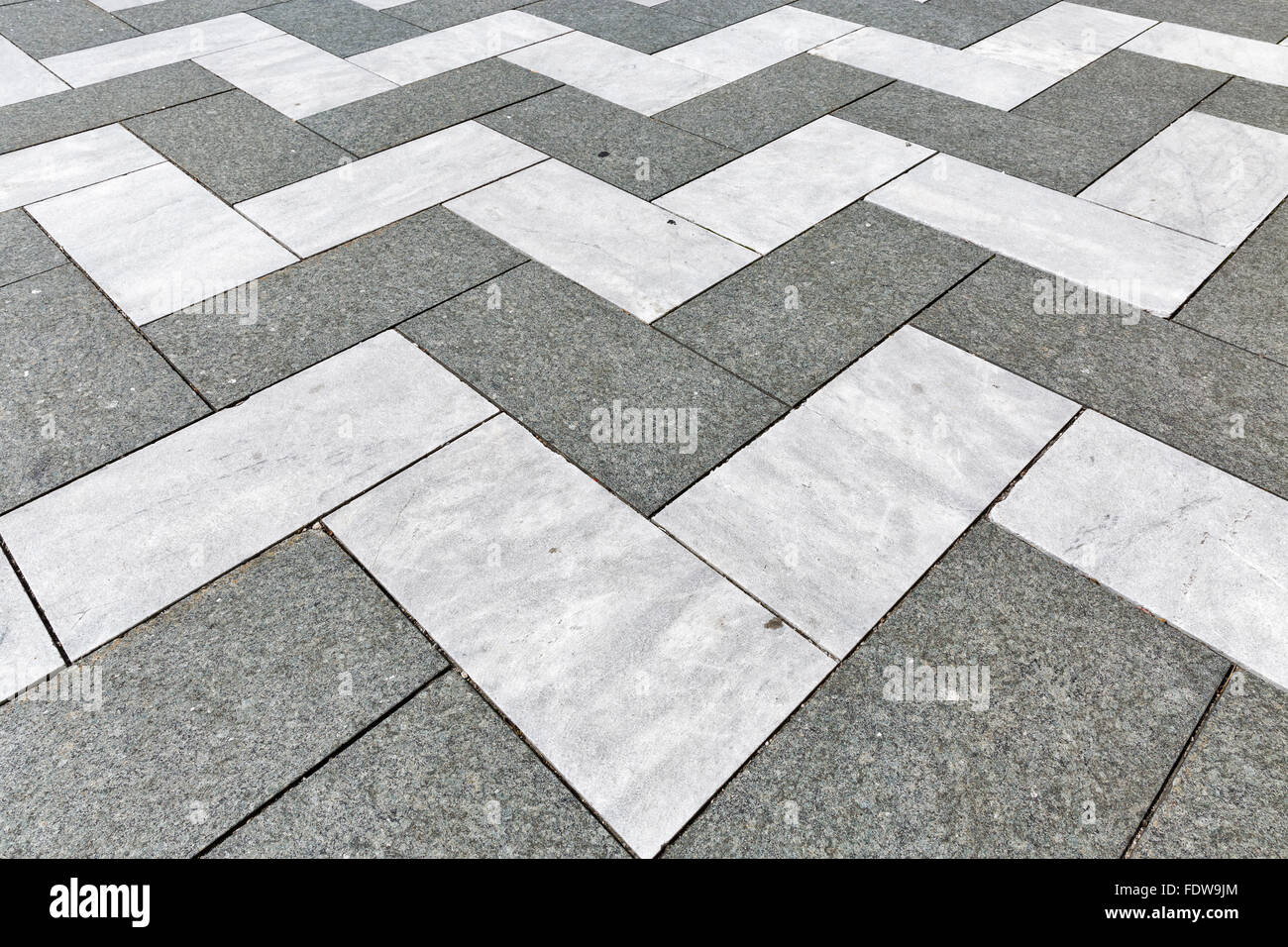 decorative old stone zigzag street tiles closeup Stock Photo