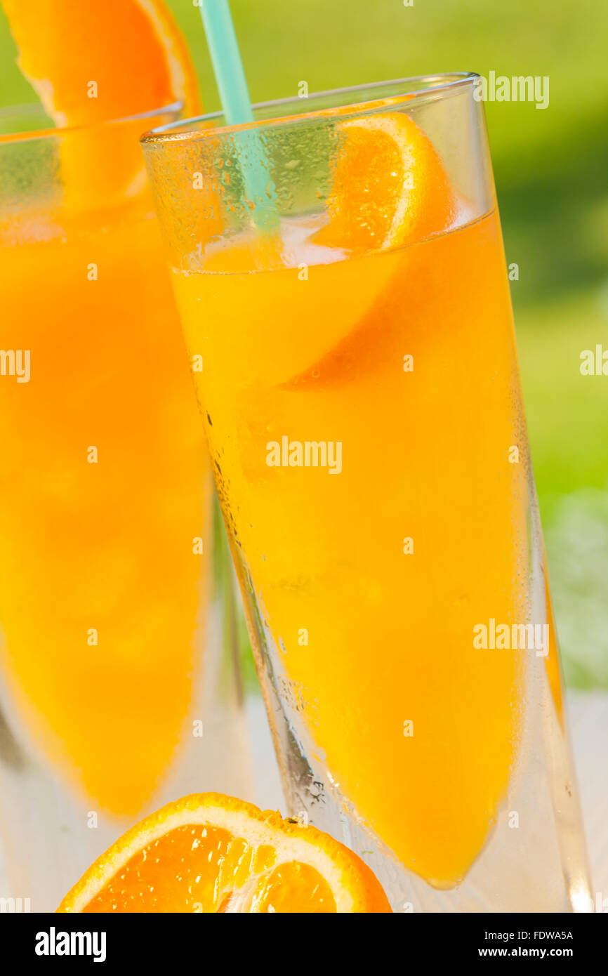 ice cold healthy orange juice spritzer drink in garden Stock Photo