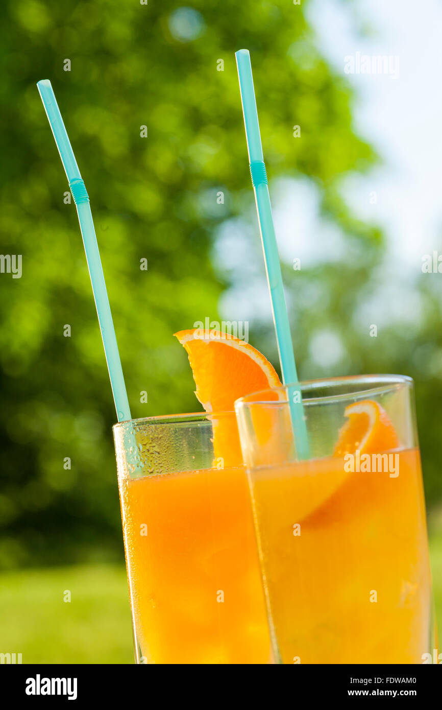ice cold healthy orange juice spritzer drink in garden Stock Photo