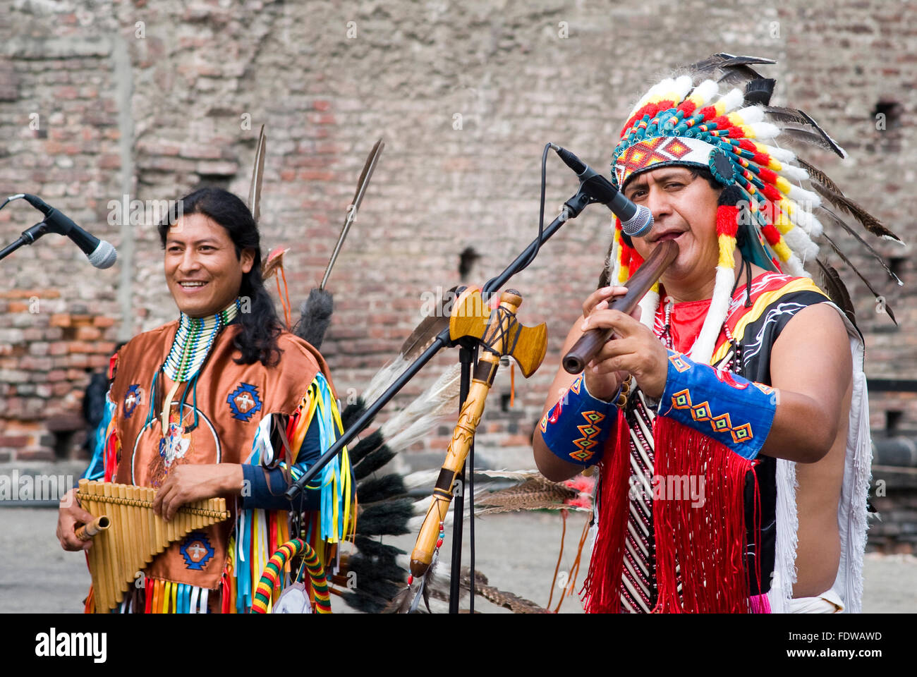 Street performance of group of Native Americans with sounds and traditional dancing in the center of Milan, Italy Stock Photo