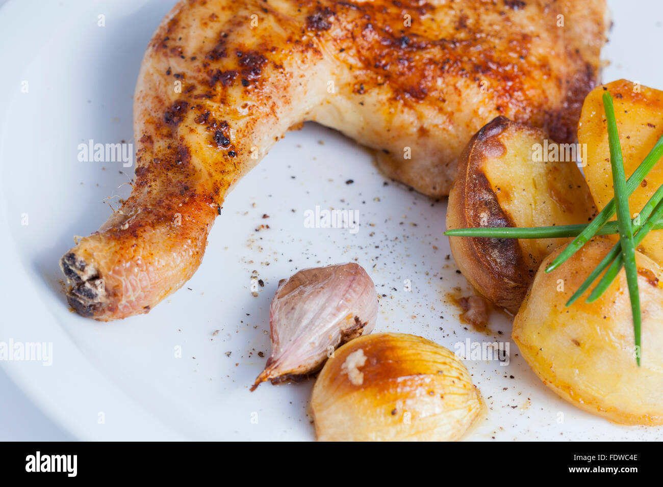 crispy roasted chicken leg with roast potatoes Stock Photo Alamy