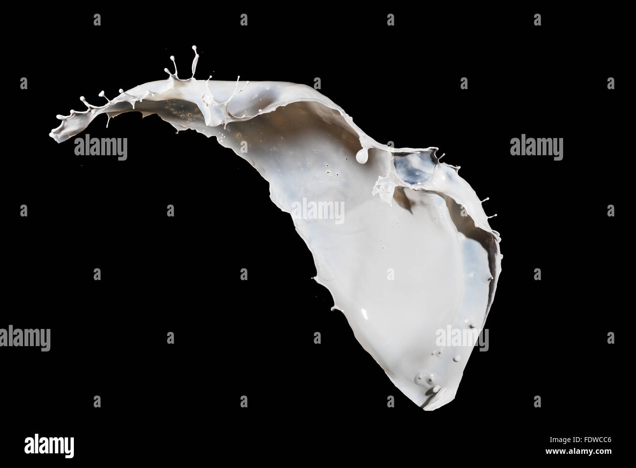 White milk splash isolated on black background Stock Photo - Alamy
