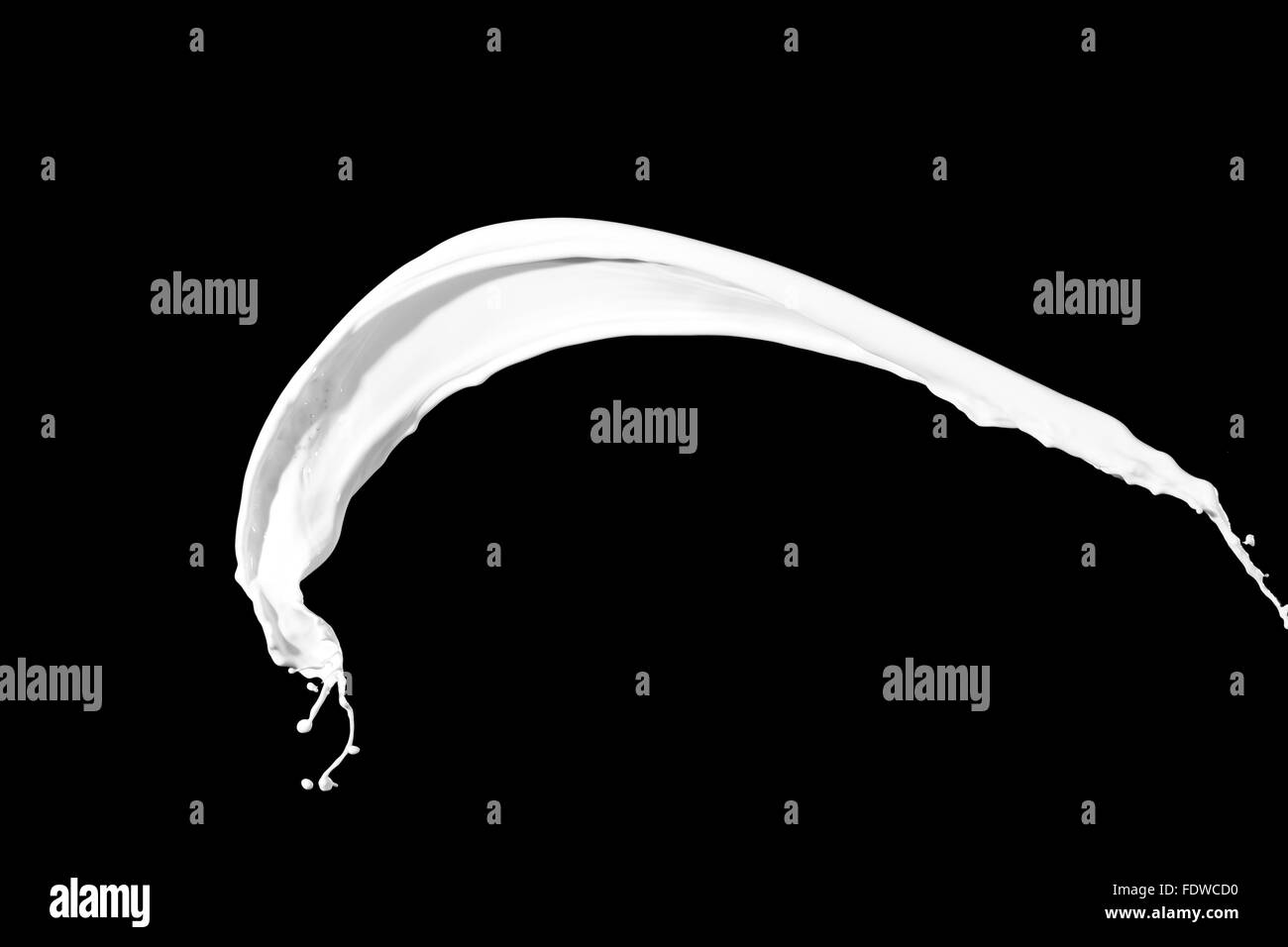 White milk splash isolated on black background Stock Photo - Alamy