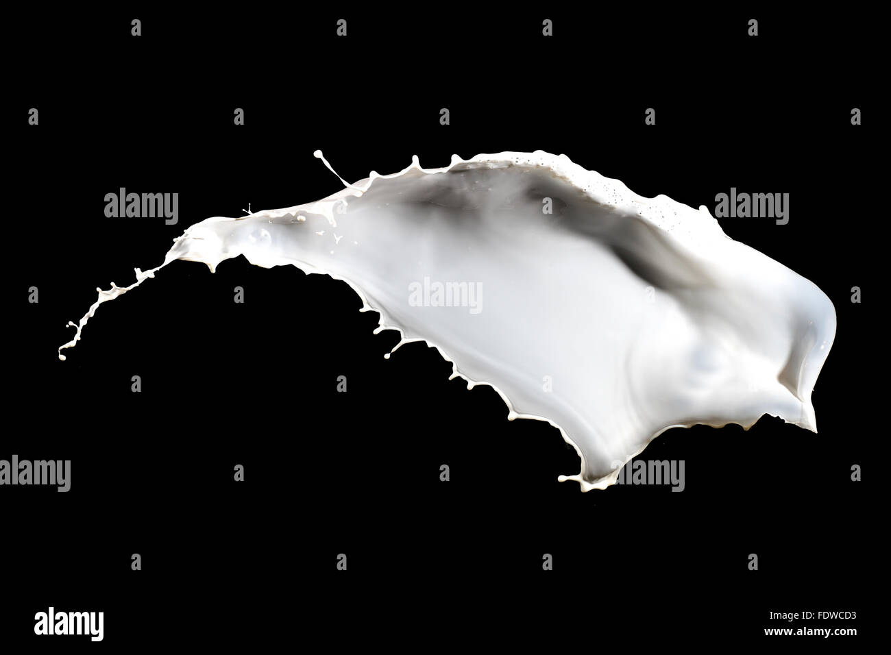 White milk splash isolated on black background Stock Photo - Alamy