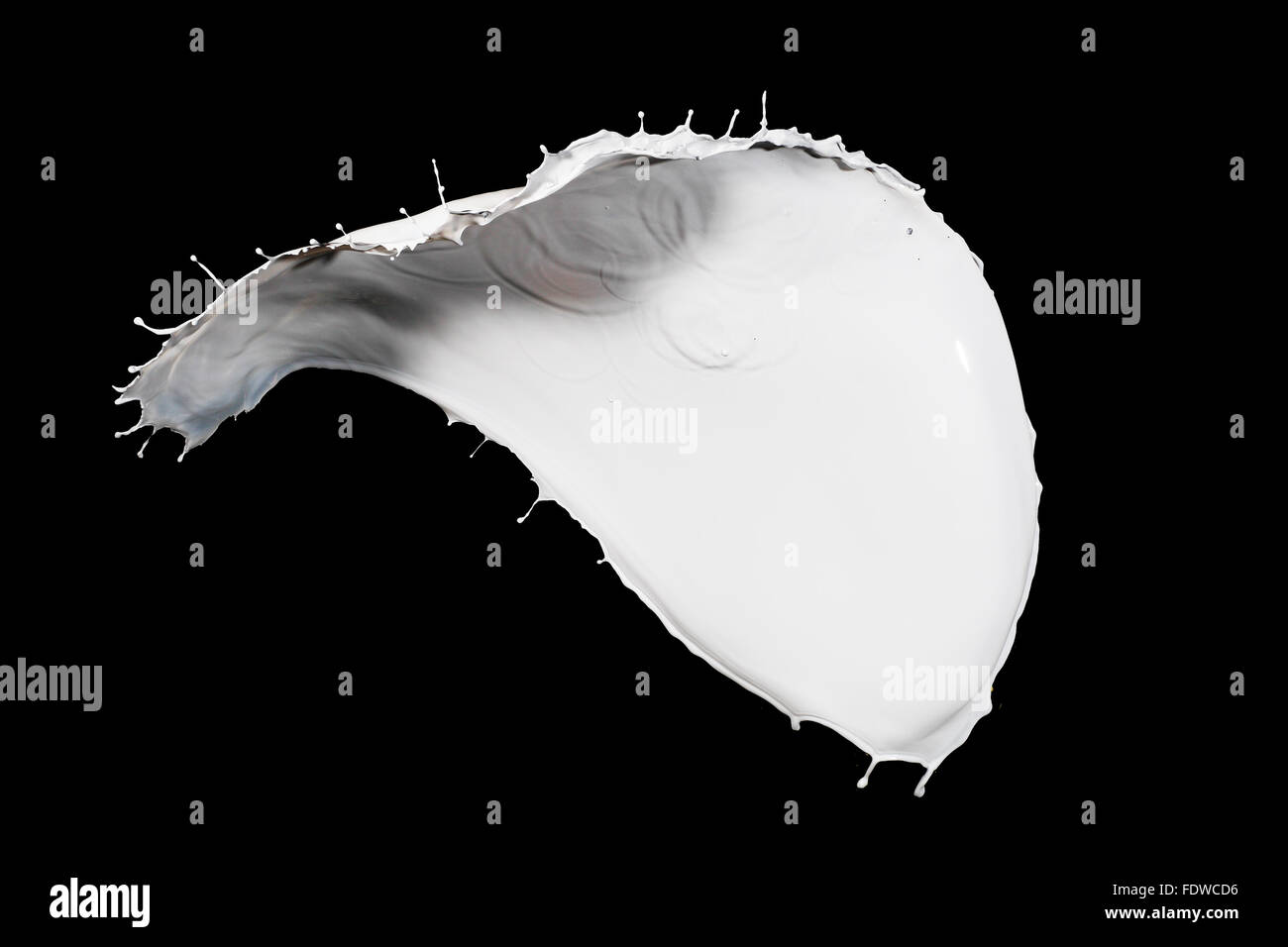 White milk splash isolated on black background Stock Photo - Alamy