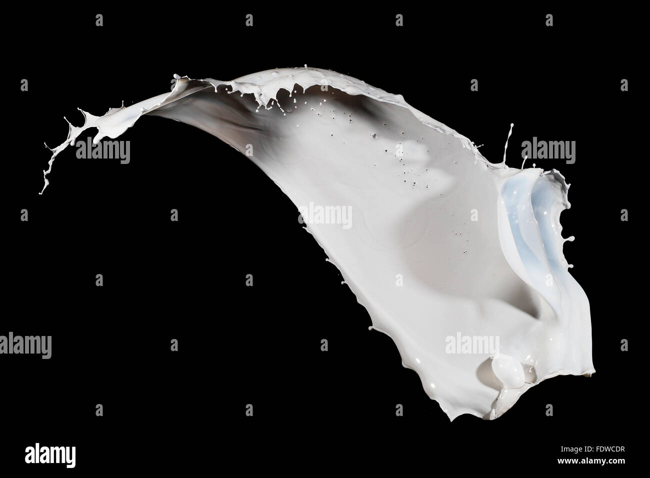 White milk splash isolated on black background Stock Photo - Alamy