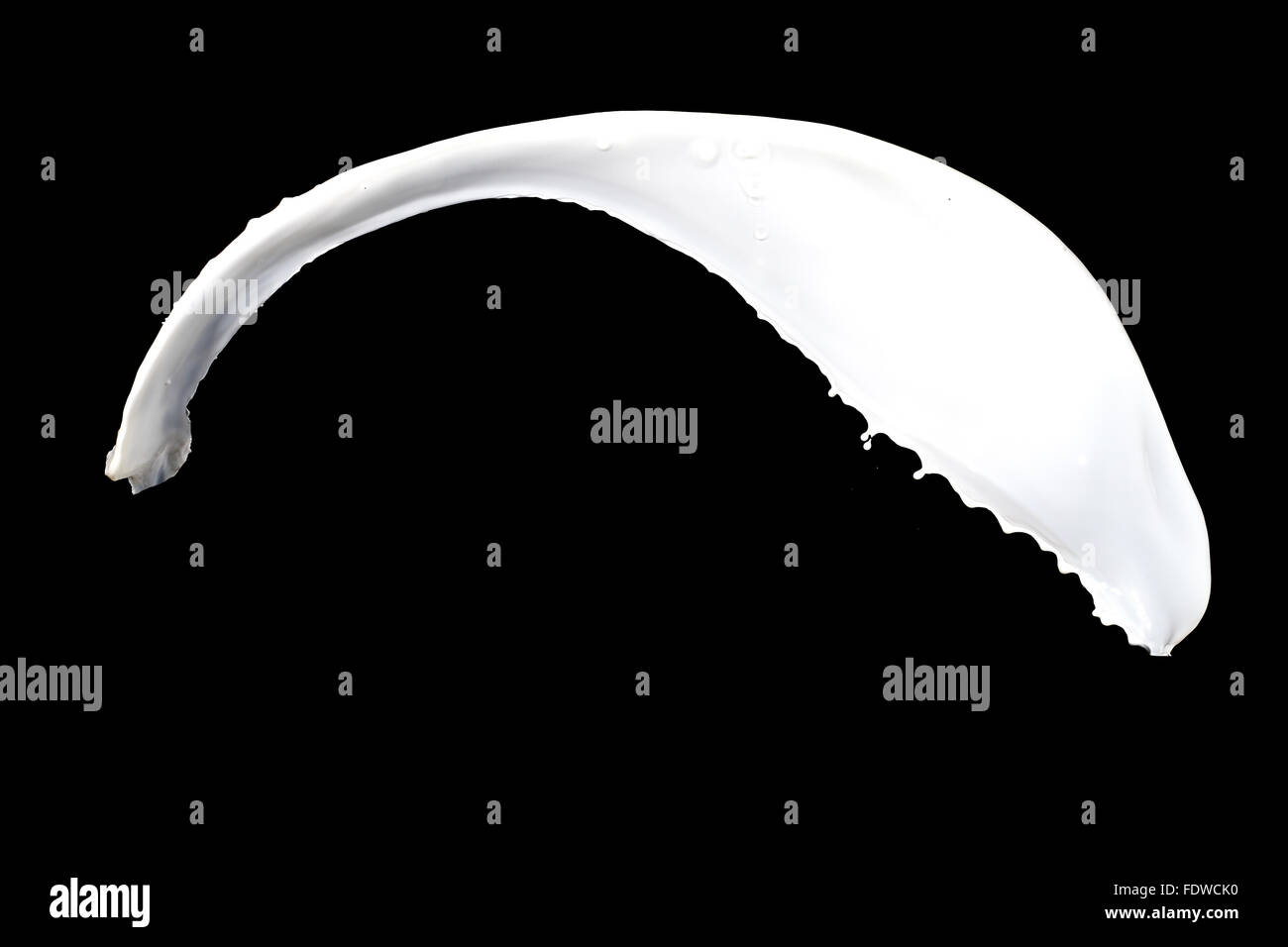 White milk splash isolated on black background Stock Photo - Alamy