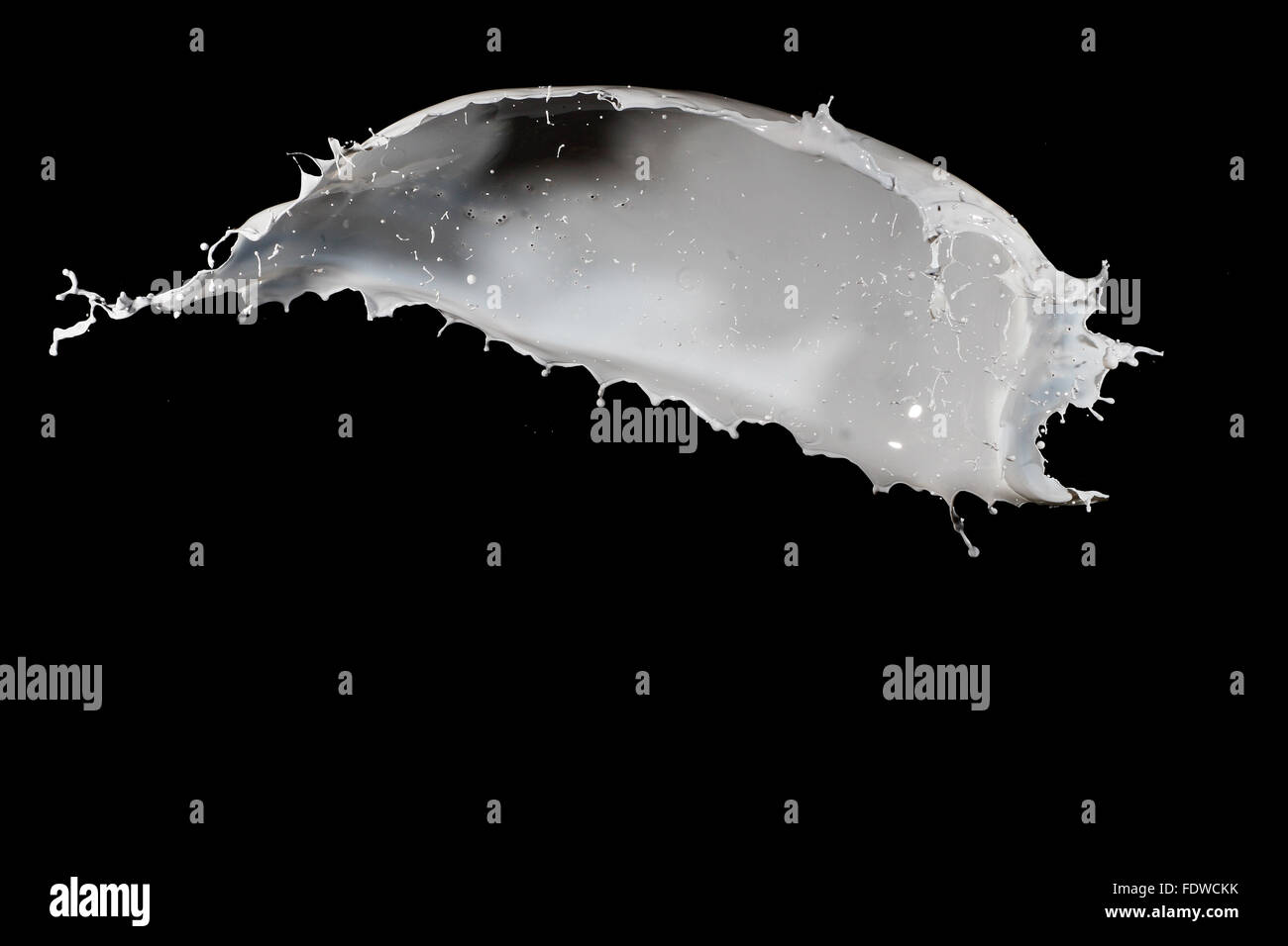 White milk splash isolated on black background Stock Photo - Alamy