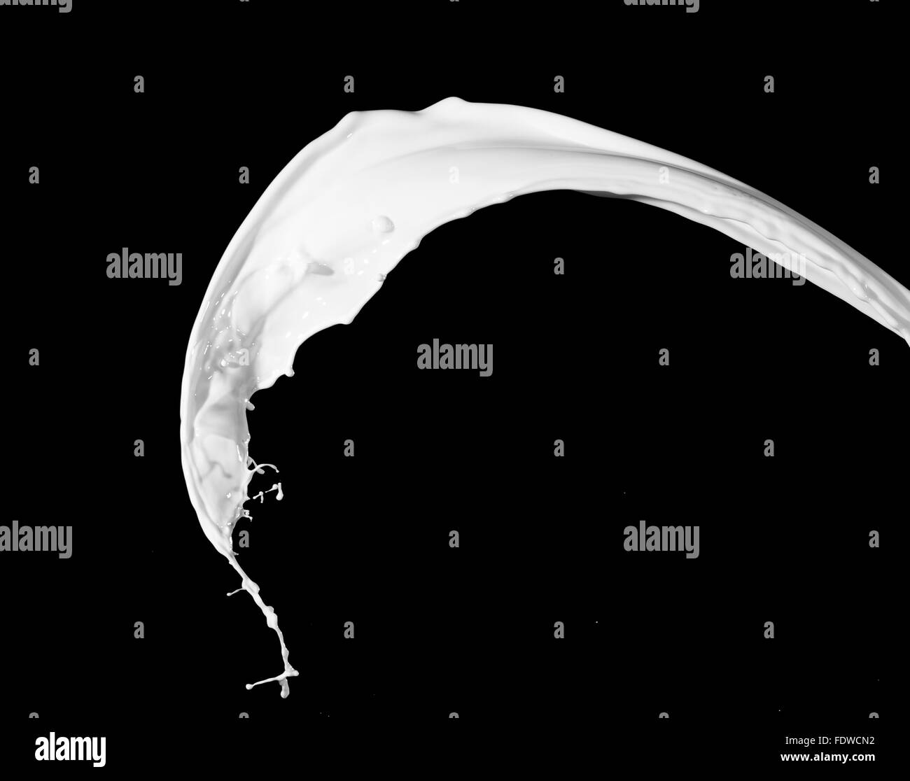 White milk splash isolated on black background Stock Photo - Alamy