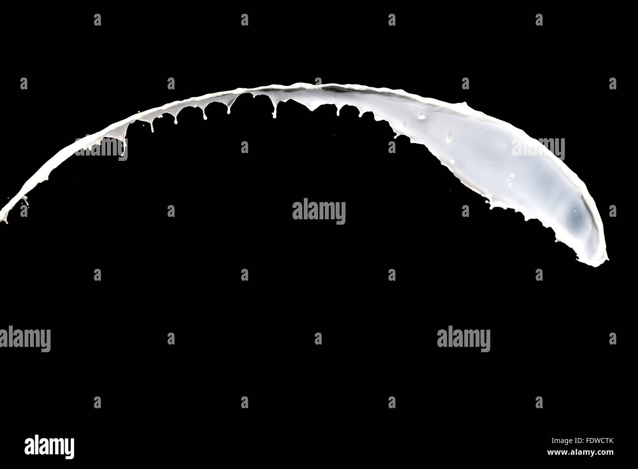 White milk splash isolated on black background Stock Photo - Alamy
