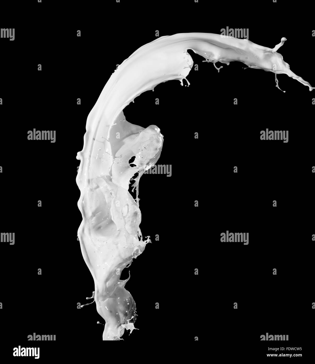 White milk splash isolated on black background Stock Photo - Alamy