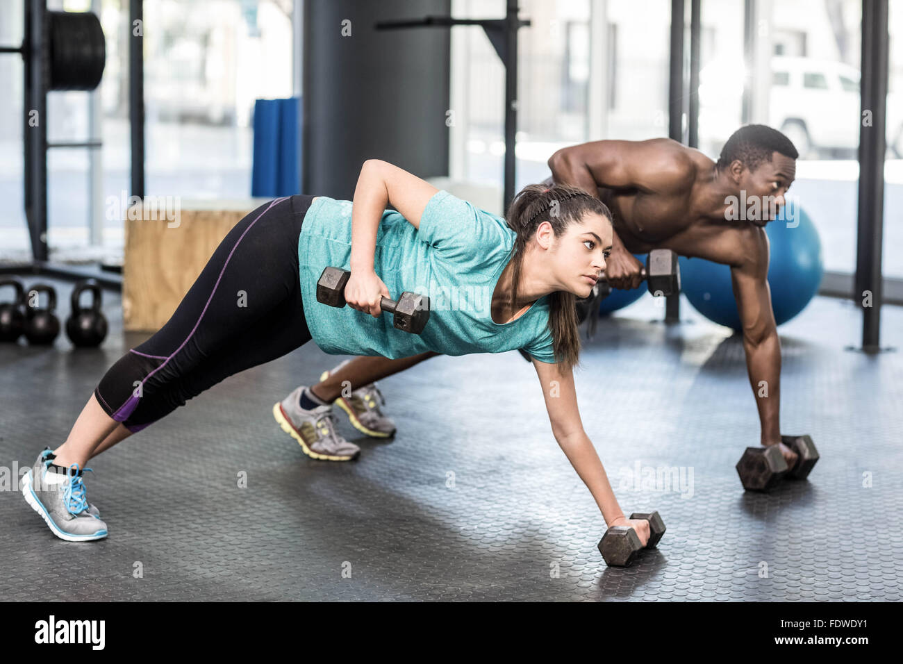 Athletic man and woman working out Stock Photo - Alamy