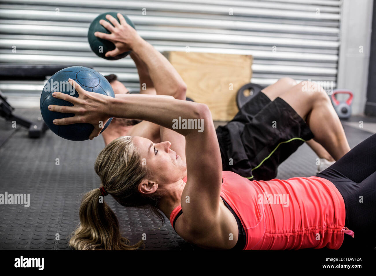 Fit couple doing abdominal ball exercise Stock Photo