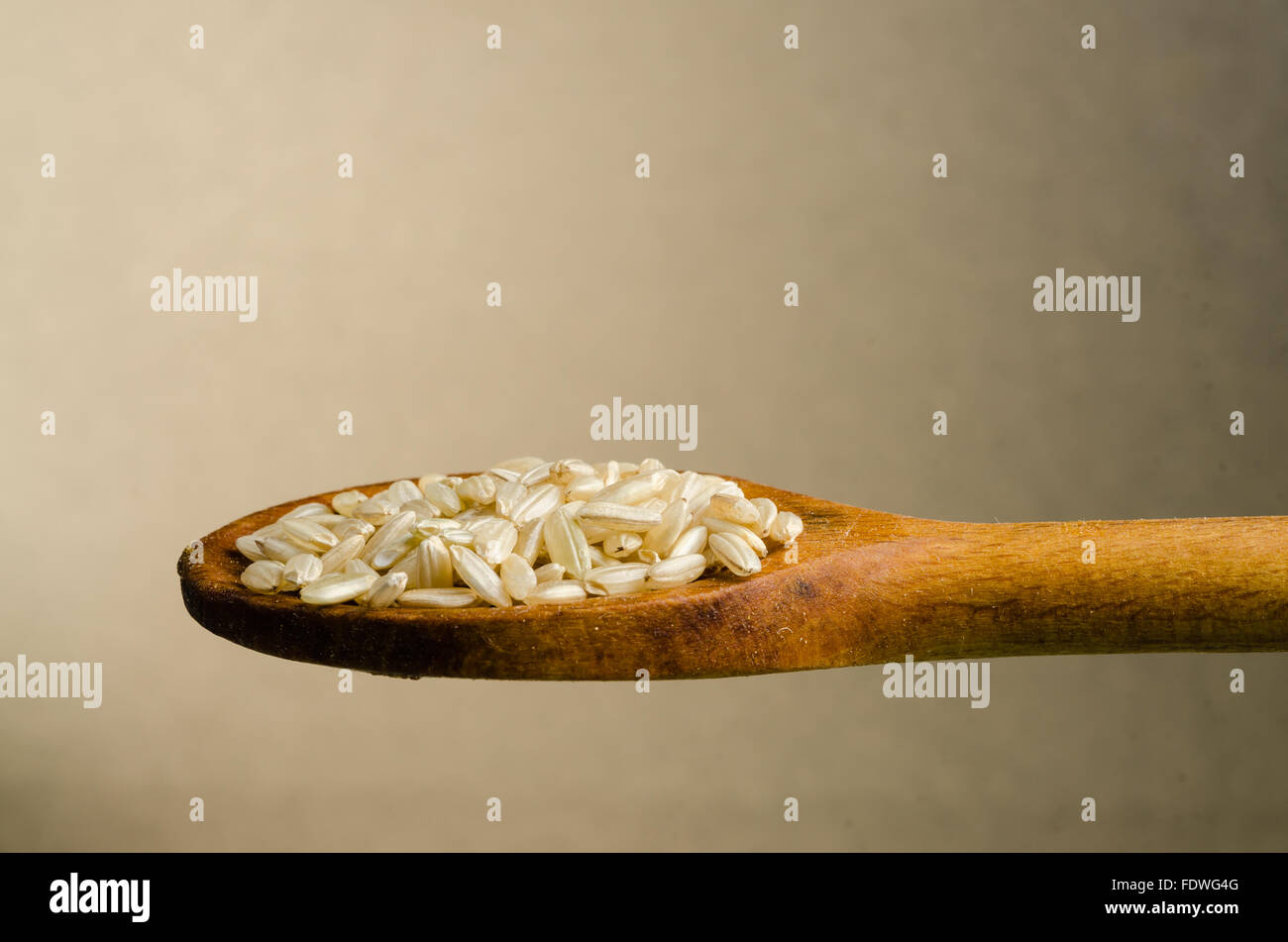 rice in a spoon, close up, color background Stock Photo - Alamy