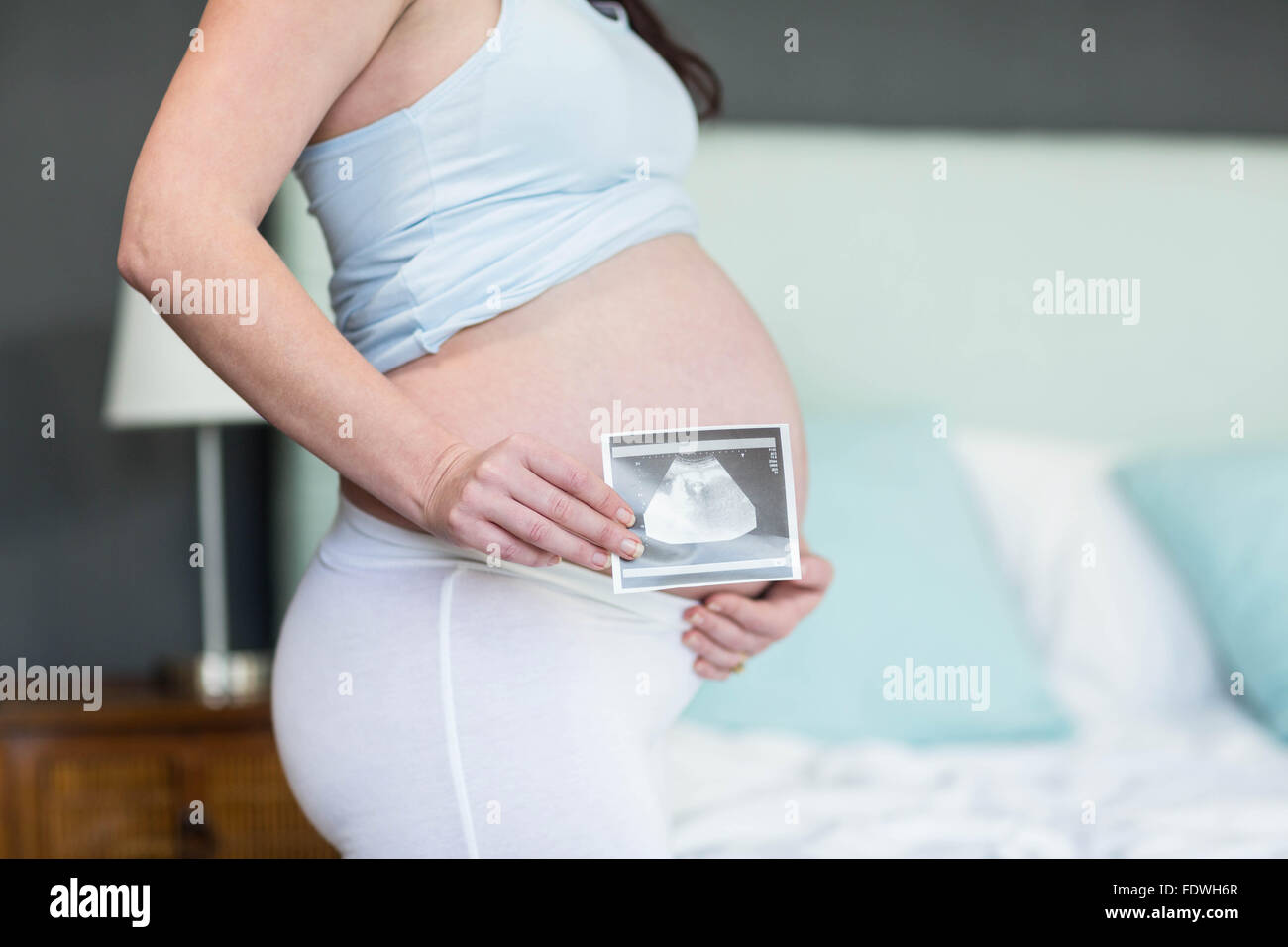 Pregnant woman showing ultrasound scan Stock Photo - Alamy