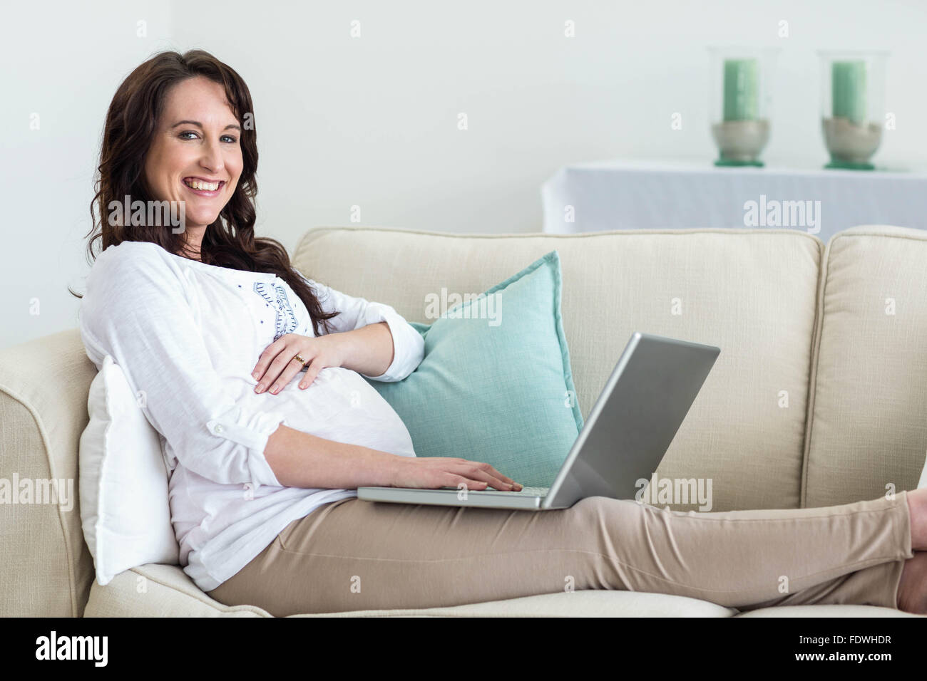Pregnant woman resting on couch Stock Photo Alamy